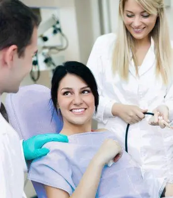 Dentist and nurse with a smiling patient